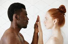 interracial couple intimate caucasian male freckles female african holding each other passionate