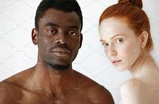 man woman young african looking male female redhead between caucasian mixed studio background interracial people couple camera race isolated posing