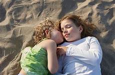 kissing sisters beach two lying cheek