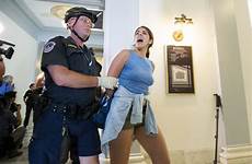 arrested protesters arizona office handcuffed police officer her away capitol led flake rally care health pinalcentral protests