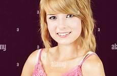 innocent cute girl young portrait blond smiling teenager alamy stock studio deep purple shot pink background over