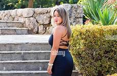 woman looking staircase voluptuous back over stairs standing steps young before serious rearview eyeshot shoulder camera eye eyes contact alamy