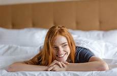 bed redhead woman lying smiling preview