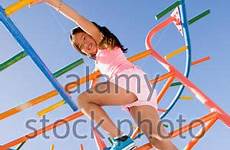 girl climbing bars monkey playground stock alamy little