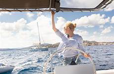 sea sailing sailboat girl steering summer hydraulic boats skipper attractive calm catamaran sunny blond navigating fancy female water blue day
