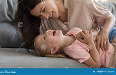 daughter tickling smiling young mommy attractive brunette