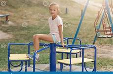 playground girl little summer sitting playing cute roundabout having fun inpark outdoors being friends top wearing outside