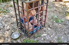 slavery little child boy cage stock