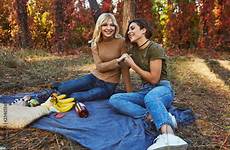 picnic laughing laying holding brunette blonde