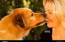 dog kissing woman blonde alamy stock