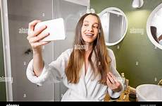 selfie bathroom girl alamy stock bathrobe making woman happy young