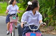 schoolgirl thai riding bicycle stock depositphotos