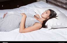 sleeping pregnant woman bed alamy