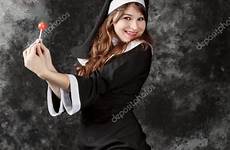 nun stockings sexy holding young depositphotos stock attractive lifted bonbon leg candy brunette dark background red girl