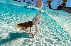 bikini pool girl swimming water handstand under over capture doing stocksy