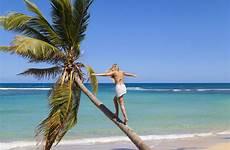 caribbean beach sunbathing palm tropical woman westend61 getty tree alternatives young