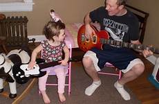 play daddy guitar she nield family intently watches sure him right very make