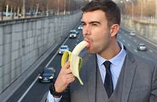 banana eating sucking man businessman provocative stock royalty guy