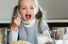 girl hungry little kasha oatmeal milk eating kitchen porridge indoors tasty table stock cook hat sweet