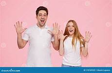 couple excited ten hands showing young overjoyed casual standing shirts together pink happy number background white