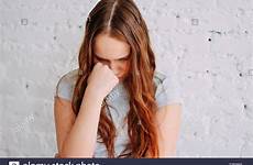 crying teen girl brick wall stock curly sad hair long red isolated alamy