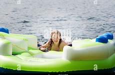 inflatable teenage girl relaxing swimming apartment holiday alamy stock raft lake pool