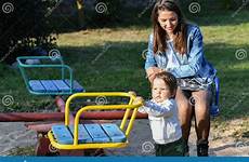 mom swing child park ride happy weekend rolls concept good childhood