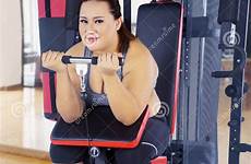 fat fitness woman exercise gym machine biceps exercising her sportswear wearing center arms