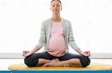 pregnant woman yoga lotus position doing sitting beautiful shot couch house