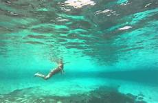 swimming nudist woman water under mykonos