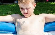 shirtless boy preteen laying pool caucasian paddling stock alamy