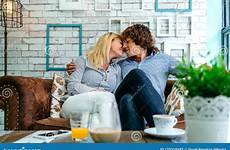 couple sofa kissing coffee shop