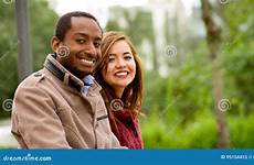 interracial romantic portrait couple outdoor happy young park stock