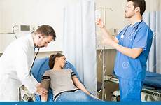 patient unconscious working doctors emergency female two doctor stock paramedic checking room preparing pressure blood hospital performing cpr preview syringe