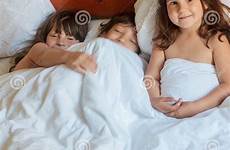 bed sleeping young boy girls children indoor portrait stock casual front