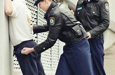 prisoner policewoman arresting cop ss officer uniforms cops shackled handcuffed
