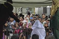 flogged christians indonesian punishment muslims punished sharia shariah violating islamic banda aceh wsj gambling crowds ibtimes