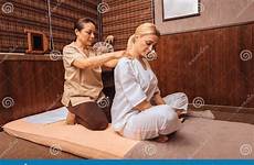 masseuse massaging shoulders