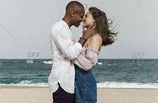 interracial couple beach young love stock