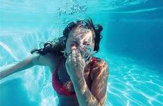 woman holding breathing underwater breath her swimming bikini pool water under swim nose stocksy jacob lund perfect without summer