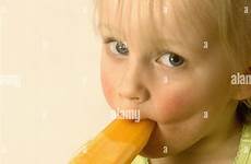 girl sucking ice young lolly stock alamy