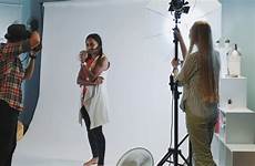 behind scenes shoot studio model photographer professional assistant working stock asking direct lighting they