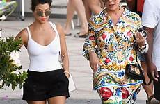 kardashian kourtney kris jenner capri corey gamble holiday enjoys boyfriend scroll down video her trouser coordinated soaked puts bright suit