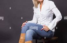 mature jeans woman sitting chair shirt white beautiful alamy stock 40s studio shopping cart