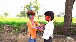 Two indian boy applying color to each other and celebrating holi festival.