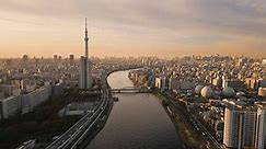 aerial view drone tokyo city skyline at dawn skytree tower asakusa district,flying over sumida river with downtown in the background at sunrise