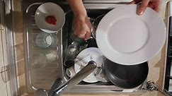 Premium stock video - A man washes the dirty dishes in his kitchen the top view