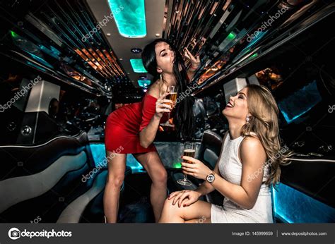 After a night out on the town, everybody stumbles drunk at 3 a.m. Girls partying in limousine — Stock Photo © oneinchpunch ...