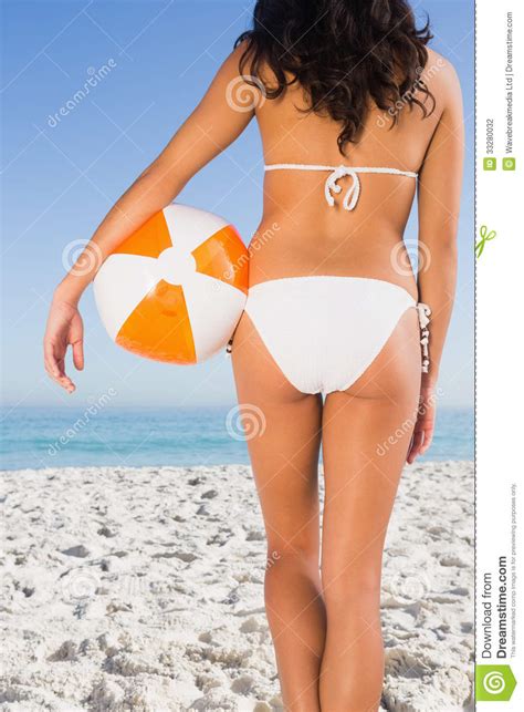 Theres nothing hotter than a warm toned oriental dragon snaking itself along. Back Of Womans Perfect Body Holding Beach Ball Stock Photo ...