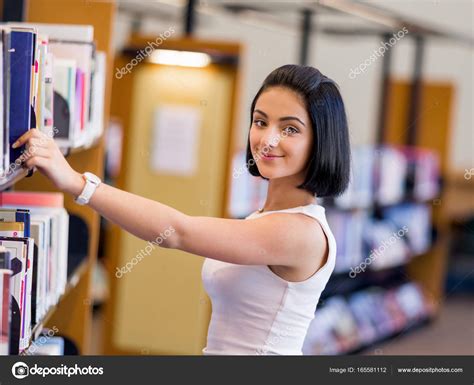 Happy female student at the library — Stock Photo © SergeyNivens #165581112